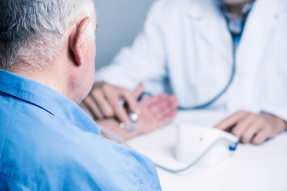 Doctor checking patient pulse to determine if they have irregular hearbeats