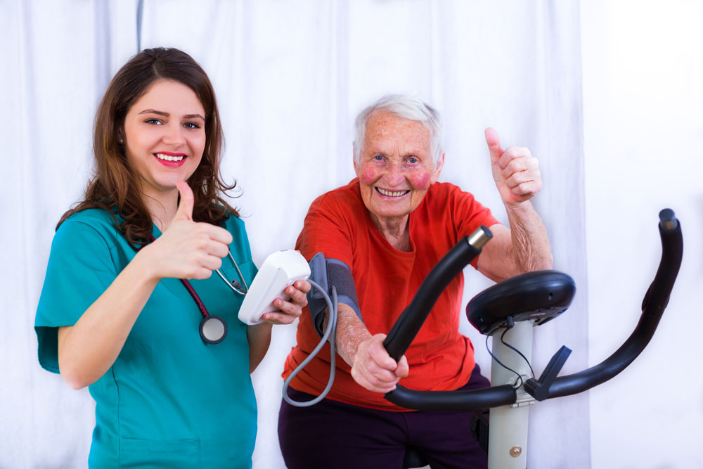 Happy old man using treadmill for cardiovascular disease care and to recover from muscle weakness