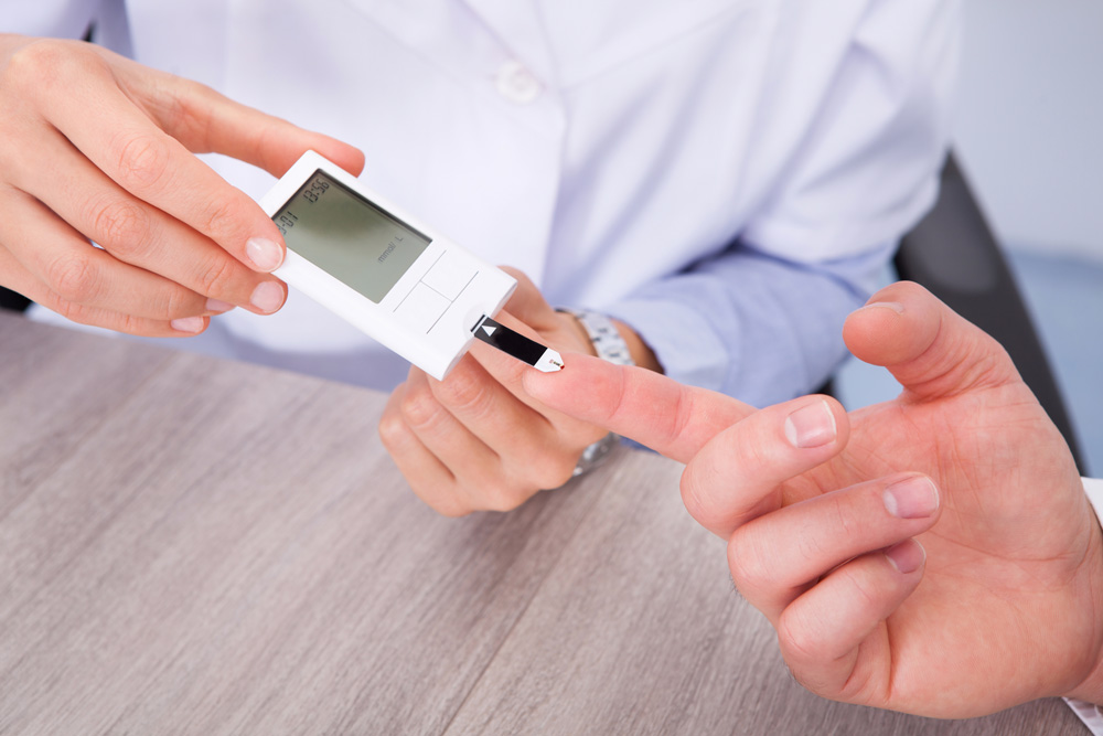 Doctor checking sugar levels of a patient suffering from diabetic foot ulcers