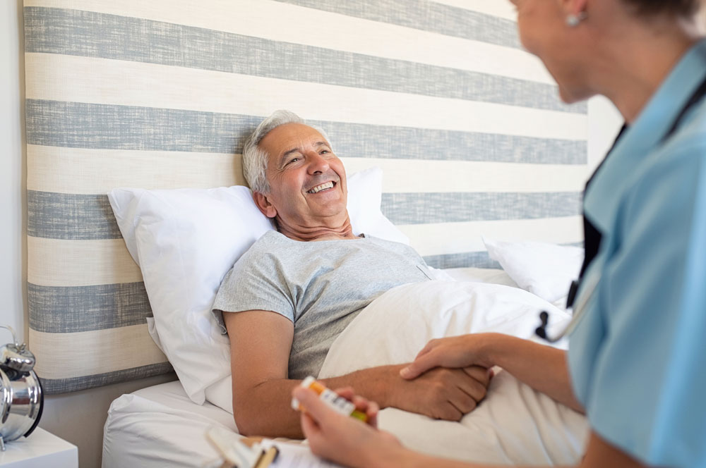 Cheerful senior man receiving health care and staying at nursing home