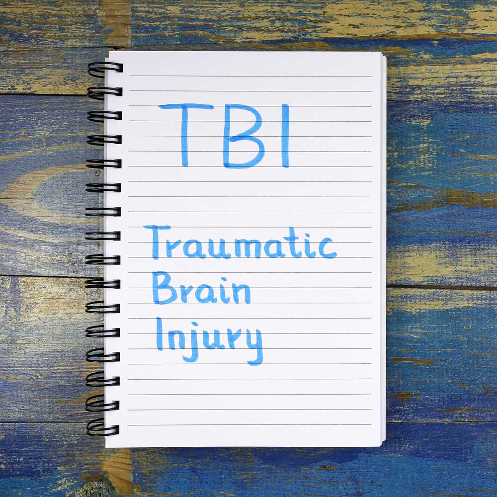 Traumatic Brain Injury written on a notepad