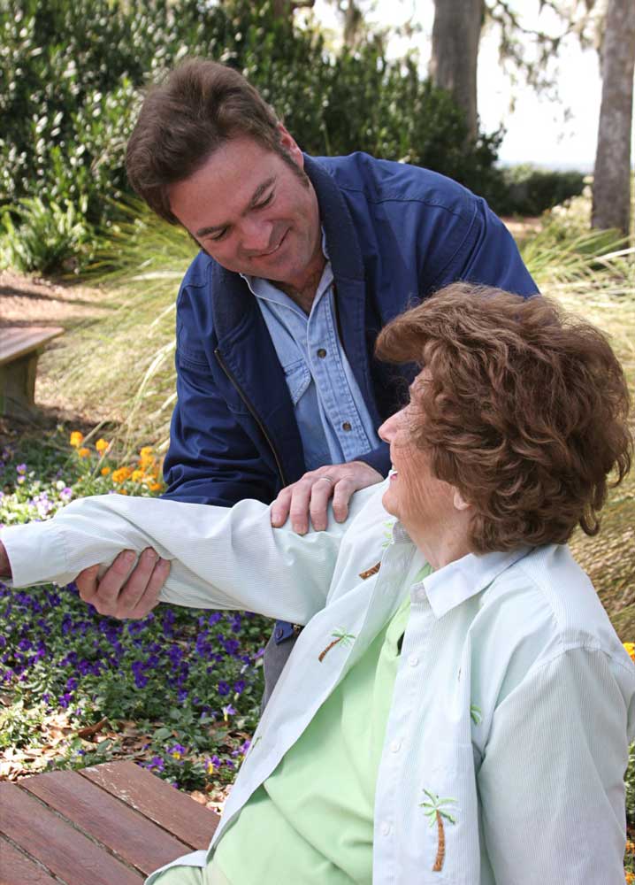 Nursing staff helping women move her hands and muscles