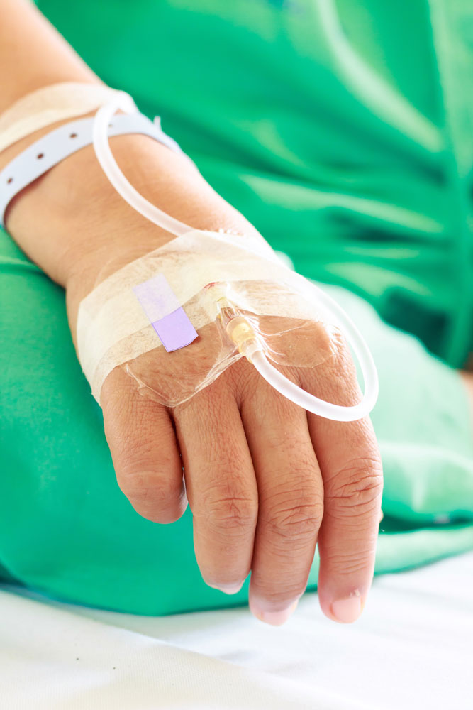 Close up of a woman patient in hospital with saline intravenous to recover from infected wounds