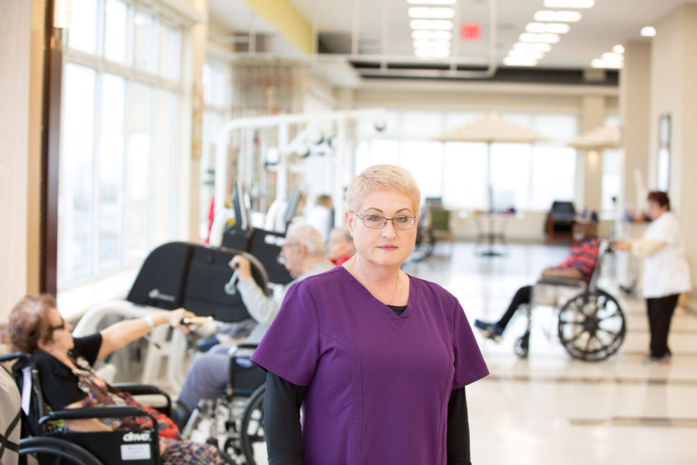 Rehab therapist portrait and people doing exercises for back injury on the background