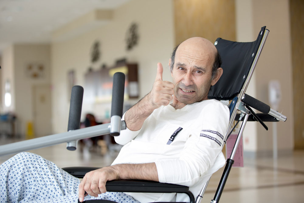 Jamshid Mirzaev thumbs up portrait on wheel chair