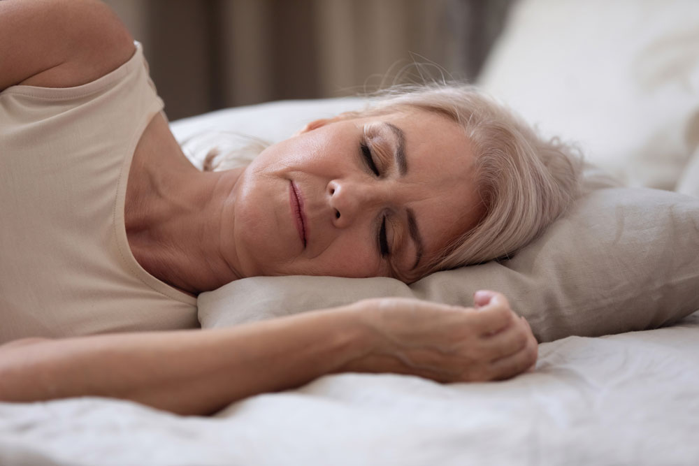 Elderly woman with diabetes sleeping on the bed alone