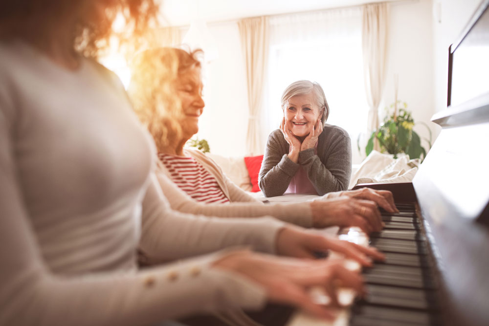 Elderly woman playing piano to relax the mind using the benefits of music