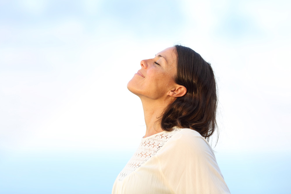 Side view portrait of a woman breathing fresh air