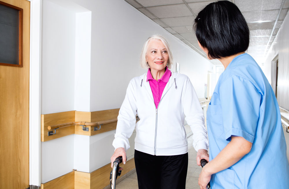 Elderly woman getting physical therapy as a part of rehab after knee surgery