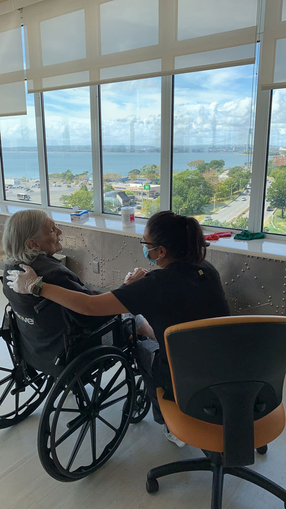 Elderly woman on wheel chair getting compassionate care at Haym Salomon Home