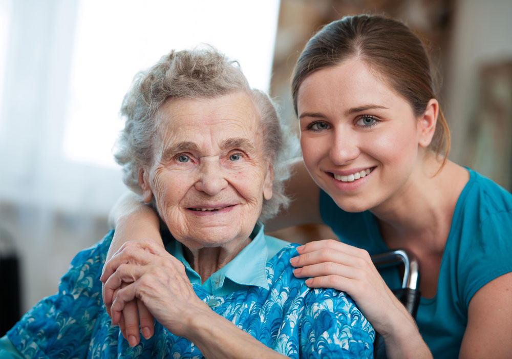 Nurse providing care to a senior female Alzheimer's patient