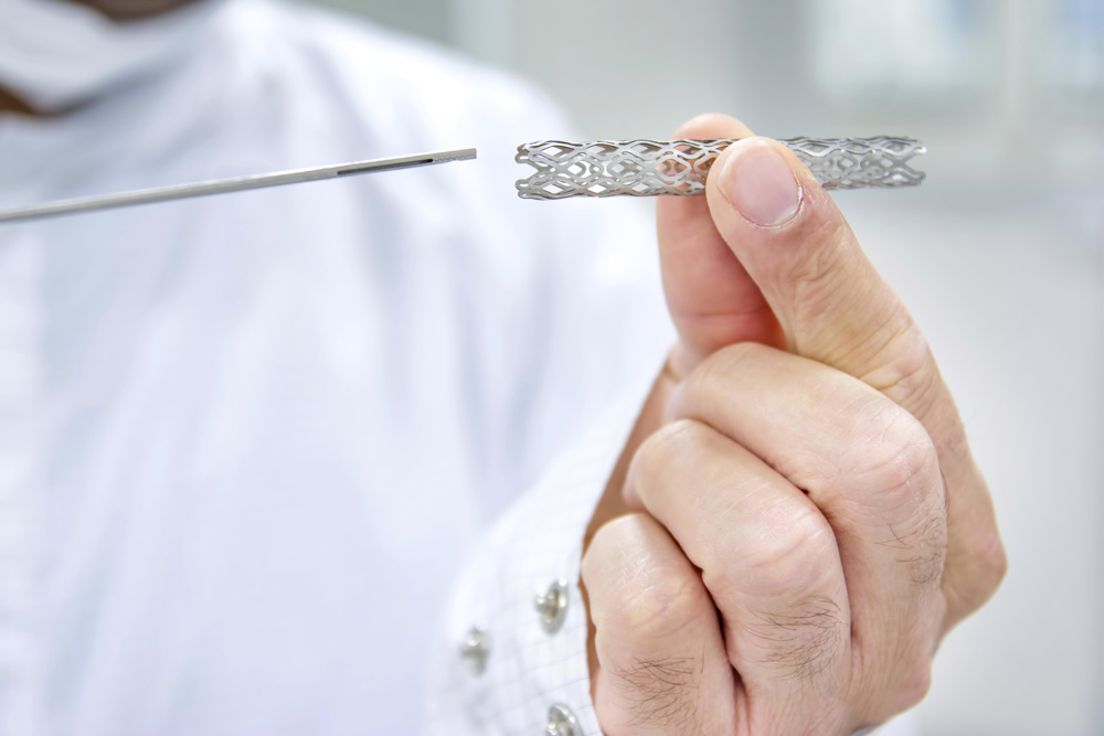 Man holding Coronary Artery Stents in his hands.