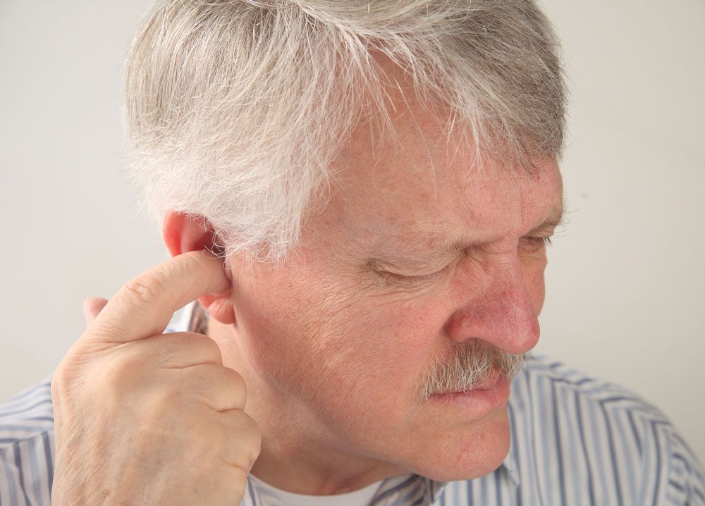 Senior man hearing heartbeat in the ears.