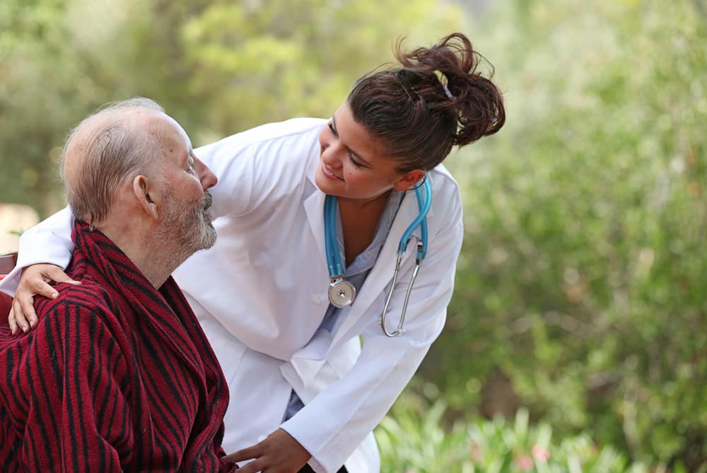 Nurse talking with a senior patient suffering from epilepsy and deep open wounds.