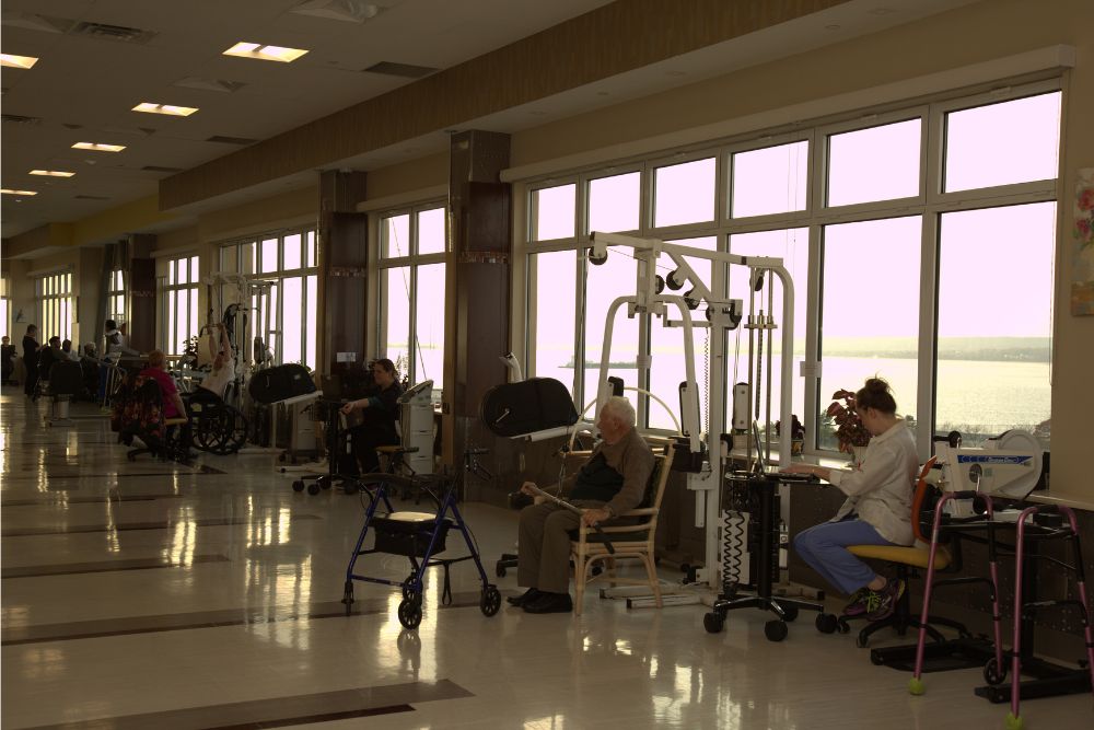 Elderly people doing exercise for broken shoulders recovery while enjoying the sunset.